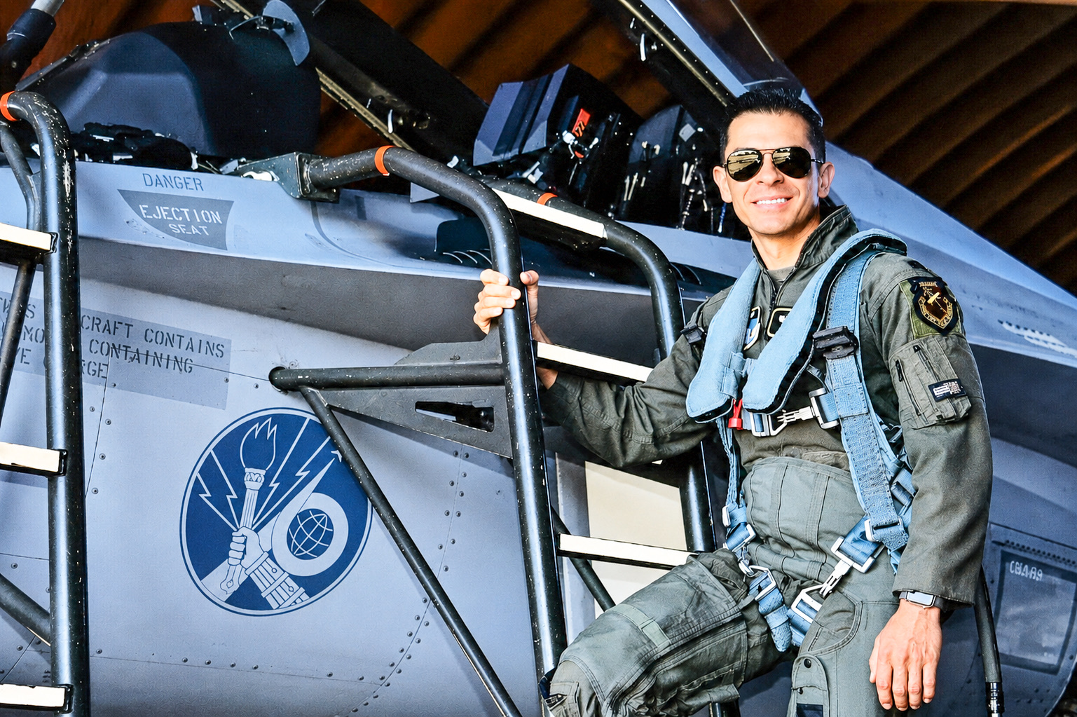 Juan Jurado in a flight suit on the boarding ladder of an F-16